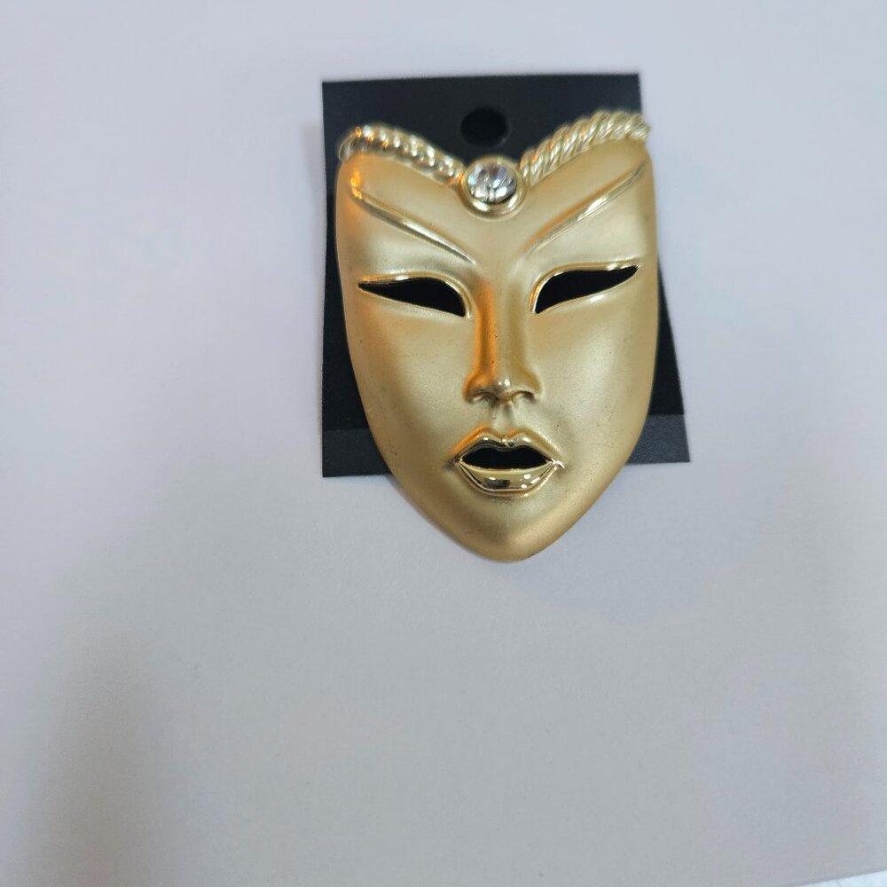 vintage gold tone venetian mask brooch features a rhinestone accent art deco